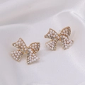 Elegant bow stud earrings with white pearls and small rhinestones on gold metal - Bow