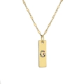 Detailed macro view of gold plated necklace with colorful rhinestone letter G pendant - Letter G