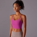 Magenta yoga crop top with thin straps and U-neck shown on a model against dark grey background - S / Lychee Pink