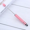 Pink dual-head retractable stylus pen for touchscreens and tablets on white desk - Pink