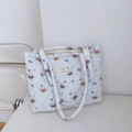 Detailed close-up of quilted tote bag featuring cartoon rabbit prints and fabric labels - Light Blue Striped Rabbit Large Shoulder Bag