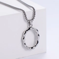 Detail of silver wavy ring pendant on chunky bead chain against white geometric background - Letter O (Pendant Only)
