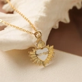 Golden necklace with a white sacred heart pendant on a decorative shell background - White Sacred Heart Style / White