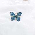 Elegant blue gradient butterfly brooch with sparkling rhinestones on white fabric background - Blue