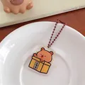 Cute brown bear in yellow box acrylic keychain with metal ball chain, size 3.2x4cm - Merit Box Bear
