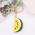Detail of yellow enamel watermelon slice keychain charm with inlaid green crystals - Yellow Watermelon Slice