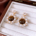 Detail of vintage gold earrings with tiger eye stone, pearls, and zircon on white velvet - Vintage Round Sun Flower Style / Silver Pin-Gold-White