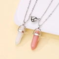 Close-up of heart magnetic clasp and hexagonal crystal pendants on silver chains - White and Pink Crystal