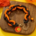 Halloween acrylic link bracelet in orange and black with spooky eyeball charm - Red Cyclops Eye Pendant