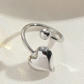 Macro detail of adjustable silver heart ring with polished ball and glossy finish - Heart / Silver