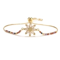 Elegante gouden bloem armband met gekleurde zirkoon en verstelbare trekkoordsluiting - Wit