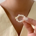 Detailopname van parelring met gouden letter Y-bedeltje om de vinger voor modieuze sieraden - Letter Y (Natuurlijke Parelring)
