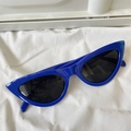 Cat eye sunglasses with royal blue frame and black lenses on white fabric - Cat Eye Royal Blue