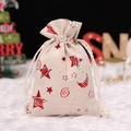 Linen Christmas drawstring gift bag with red glitter star pattern on a white faux fur rug - Red Stars Moon