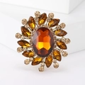 Vintage palace style brooch with amber oval crystal and champagne rhinestones on a white base - Brown