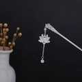 Detailed close-up of silver hollow lotus hair pin with tassel and turquoise bead - Silver/F149/Hollow Lotus Bead
