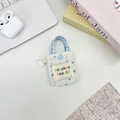 Floral canvas mini storage pouch with blue flower patterns and button closure - White