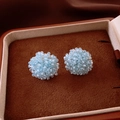 Light blue beaded sphere stud earrings presented in a luxury brown velvet jewelry box - Woven Ball / Light Blue