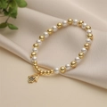 Fashionable Hamsa Hand charm bracelet featuring golden beads and white imitation pearls - Hamsa Hand Pendant