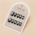 Close-up of black holographic cat eye press-on nails with heart and star patterns - By1645 / Glue Type