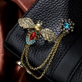 Vintage gold bee brooch with rhinestones and chain link on a black leather background - TL0012-Vintage-Blue Bee