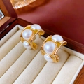Detail of vintage gold pearl earrings in a wooden jewelry box with soft velvet lining - Vintage C-Shape Beaded Edge Pearl Style / Gold
