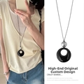Close-up of retro long sweater chain with black resin ring and silver bead pendant. - Black and Silver