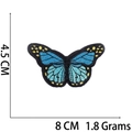 Detailed view of blue butterfly embroidered patch with dimensions 8cm x 4.5cm and dimensions - No.16 Blue Butterfly