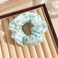Blue and white plaid floral lace scrunchie displayed on a beige velvet jewelry tray - Plaid Blue