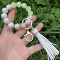Luminous beaded bracelet keychain with white tassel and leopard print beads on grass - Beige Gold Plaid