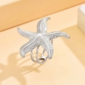 Starfish adjustable stainless steel open ring with textured relief on beige background - J03342 / Silver