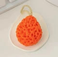 Orange honeycomb bath sponge with soft porous texture and white hanging rope for skin care - Orange