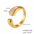 Detailed view of 6mm golden open ring with teardrop oil drip enamel finish and steel band - Size 7 / White Enamel Open Style (A584) / Gold