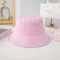 Detailed view of a pink cotton bucket hat on a white table with minimalist decor - M / Small Brim / Pink