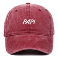 Close-up of embroidered PAPI logo on vintage washed red cotton baseball cap - Burgundy