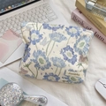 Detail of floral makeup bag with blue flowers, butterfly prints and leather brand tag - Blue Floral