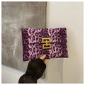 Detail showing the purple leopard print handbag with elegant golden metal buckle detail - Purple