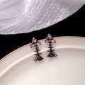 Pink zircon fishbone stud earrings in gunmetal finish displayed on white ceramic - Black with Pink Rhinestone