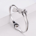 Elegant silver-tone double heart open bangle with sparkling cubic zirconia accents - Steel