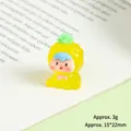 Detailed macro view of 15x22mm resin pineapple mini figurine resting on book pages - Luminous Pineapple