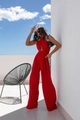 Detail of red halter jumpsuit showing side waist cut-out and wide-leg woven fabric flow - S / Red