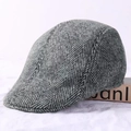 Close-up of grey herringbone wool flat cap showing textured fabric and side profile - Light Grey Herringbone