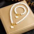 Macro detail of gold-plated pearl jewelry set with heart pendant and toggle closure - Heart Necklace Bracelet Set (N2855 B1401)