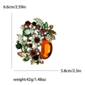 Broche de flor con cristales de colores y medidas 6,6cm por 5,8cm en fondo blanco - Champaña