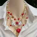 18k gold plated layered necklace with pearls, red heart and cherry pendants on a model - Layered Necklace Combination / Gold Red White Mix