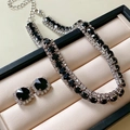 Detail of silver drop necklace and earrings set with black crystals in a jewelry box - Silver Black