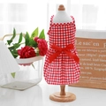 Detailed close-up of a red and white checkered pet dress with a large red ribbon bow - Red Plaid