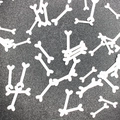 Halloween party table confetti featuring scattered white dog bone shaped sequins for decoration - White Bone