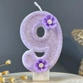 Number 9 birthday candle in purple with glitter finish and small flower decorations - Number 9