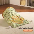 Cat play tunnel in light green hedgehog print with paw-shaped window and plush balls - Three-layer Crinkle Cat Tunnel / Hedgehog Style (Light Green)